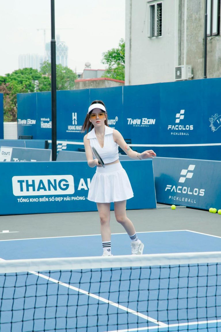 Female tennis player practicing on an outdoor court in Hải Phòng, Vietnam.